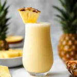 Virgin Pina Colada mocktail with pineapple and cherry garnish