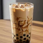 Black milk tea boba with tapioca pearls in tall glass