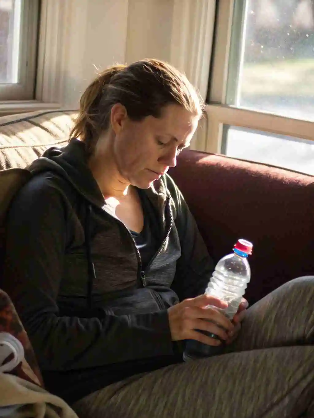 zepbound-fatigue-woman-tired-closeup Woman tired from Zepbound fatigue sitting on couch
