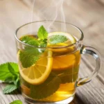 lemon balm tea recipe for weight loss in a clear mug with lemon slices